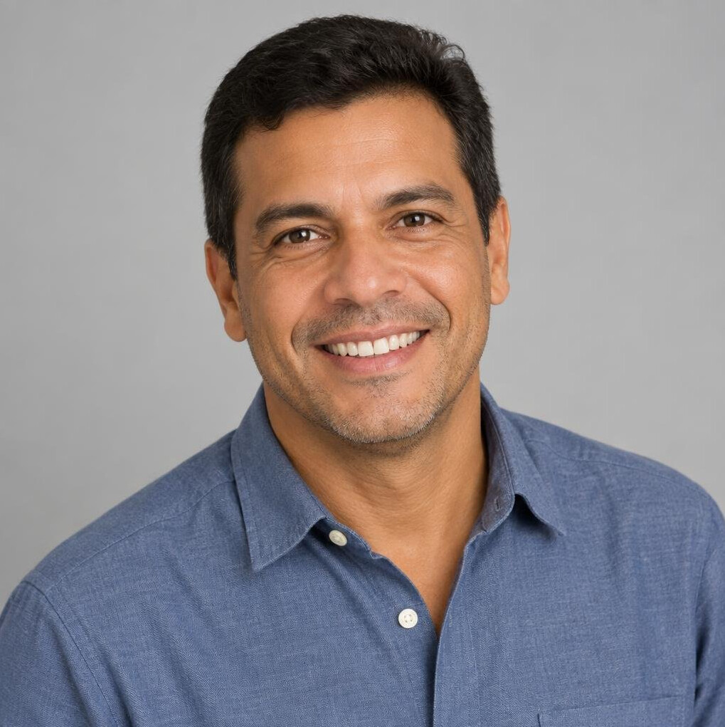 Studio portrait of a brazilian man in his forties smiling